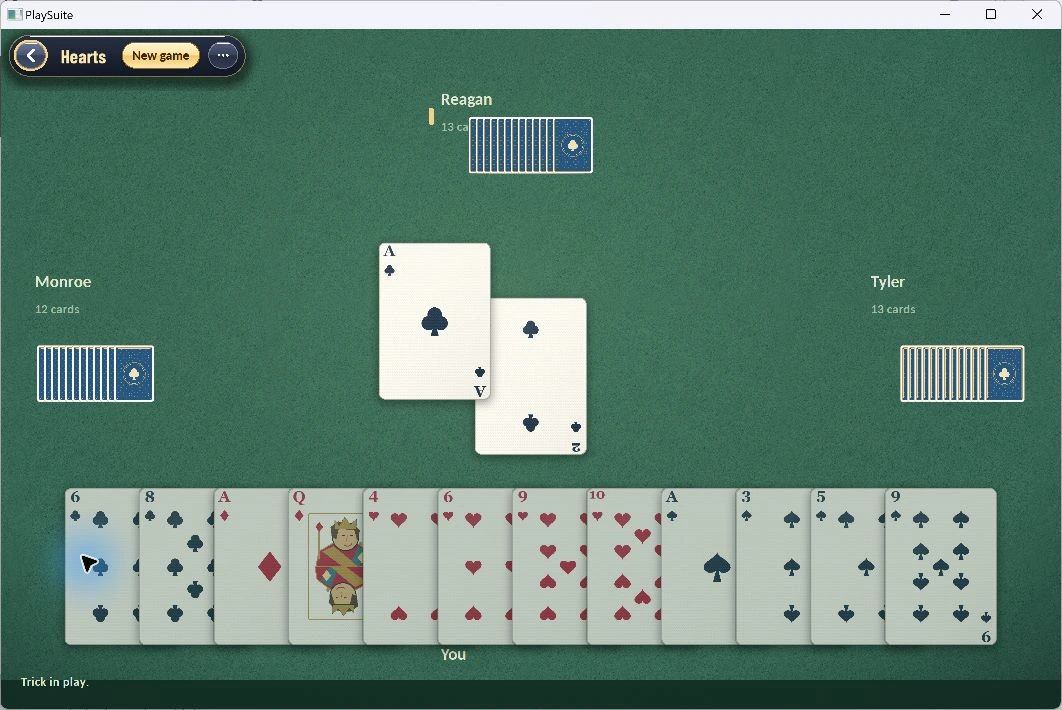 A four-player Hearts table with the player’s hand and computer opponents.
