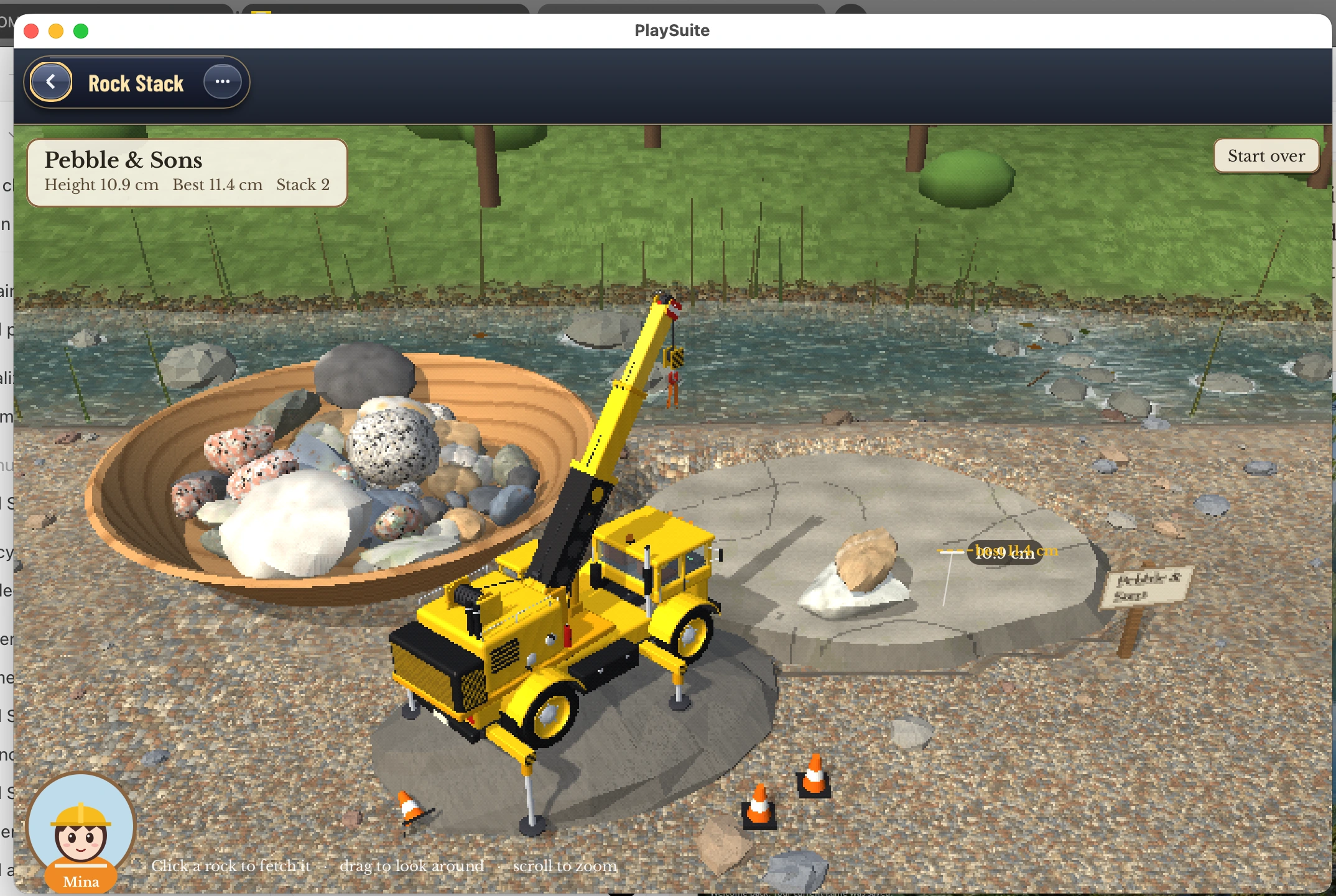 A yellow crane beside a brook, a bowl of river stones, and a two-rock stack measuring 10.9 cm.
