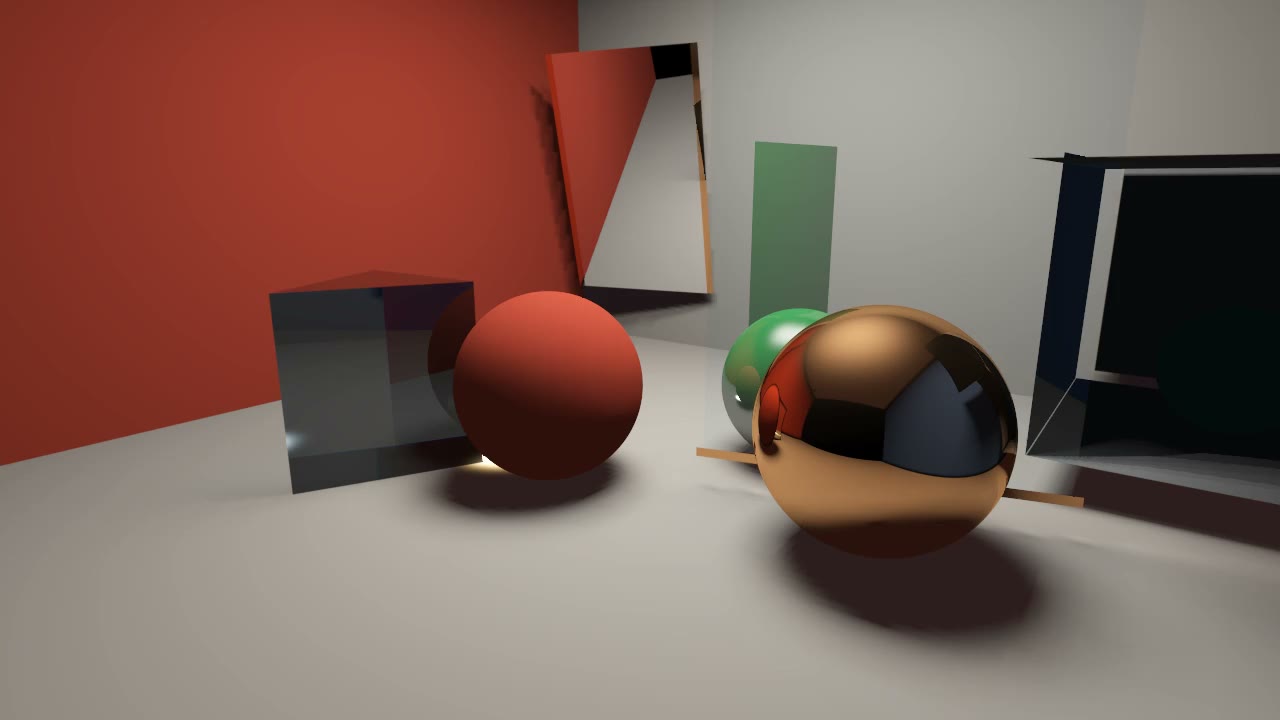 Close view of red, green, and copper spheres beside glass and a dark cavity