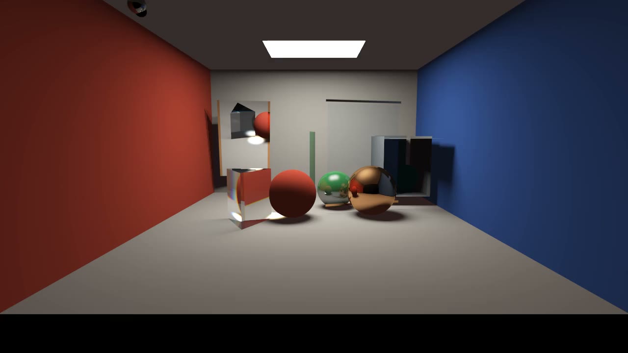 Wide view into a red, white, and blue room containing a prism and three colored spheres